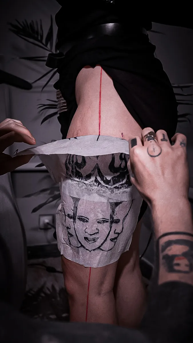 A hand-inked transfer print pressed onto a guest's skin