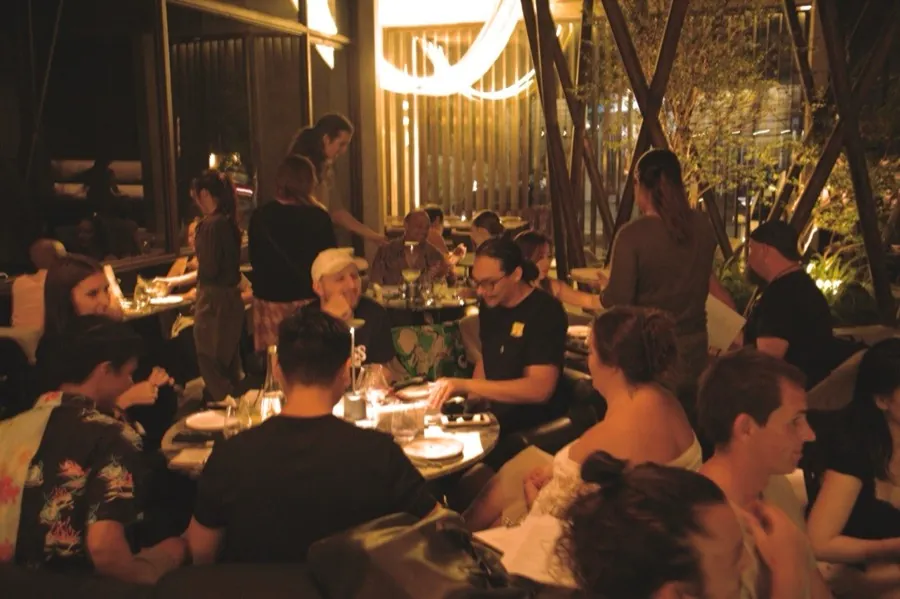 Members at a candlelit dinner gathering